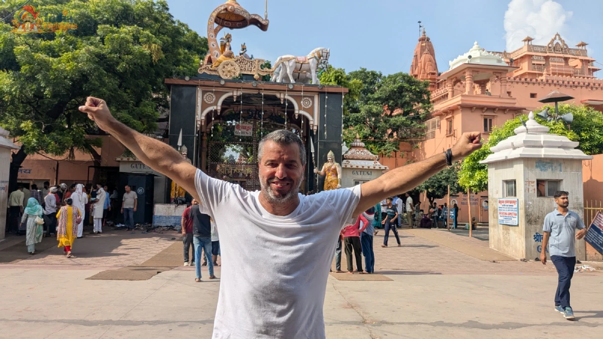 Spiritual Joy at Shri Krishna Janmabhoomi, Mathura Enthusiastic traveler posing with outstretched arms outside Shri Krishna Janmabhoomi temple gate in Mathura
