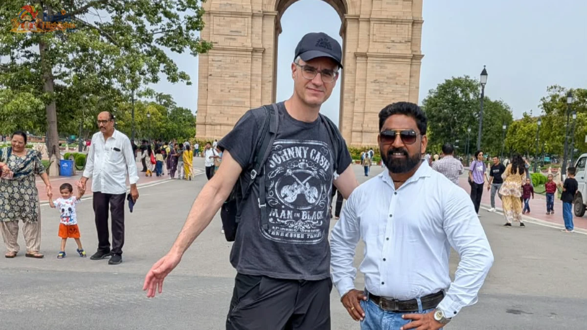 Historic Landmark Sightseeing at India Gate, New Delhi Traveler and India Highlights guide posing together in front of the monumental India Gate in New Delhi