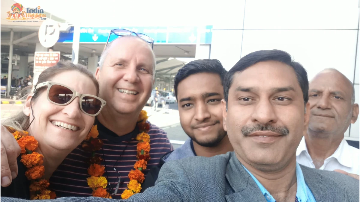Cheerful Group Welcome Selfie with Tour Team Joyful group selfie of tourists wearing flower garlands with India Highlights tour managers at airport arrival